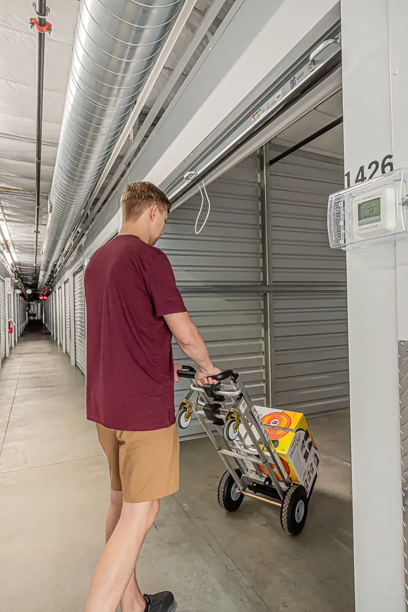 Man moving items into a storage unit